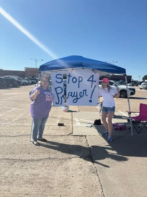 A Stop 4 Prayer sign at an outreach tent